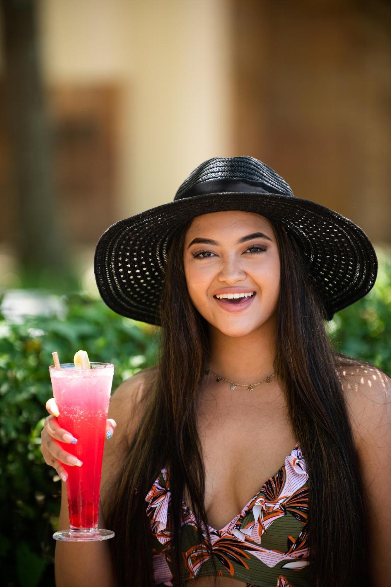 The Capital Zimbali Hotel Ballito Exterior photo A woman wearing a sun hat