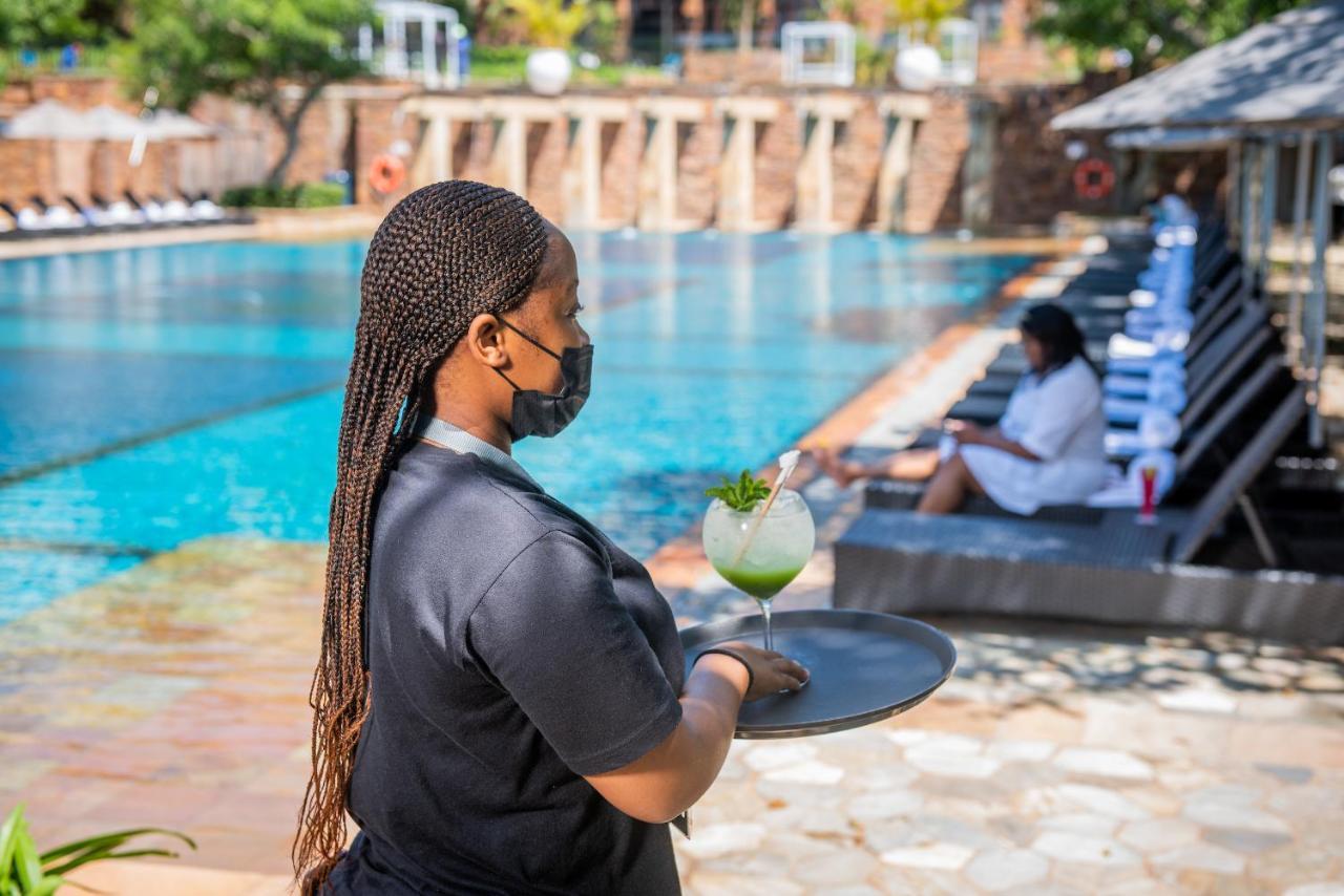 The Capital Zimbali Hotel Ballito Exterior photo A waitress wearing a face mask at a hotel in Kigali, Rwanda
