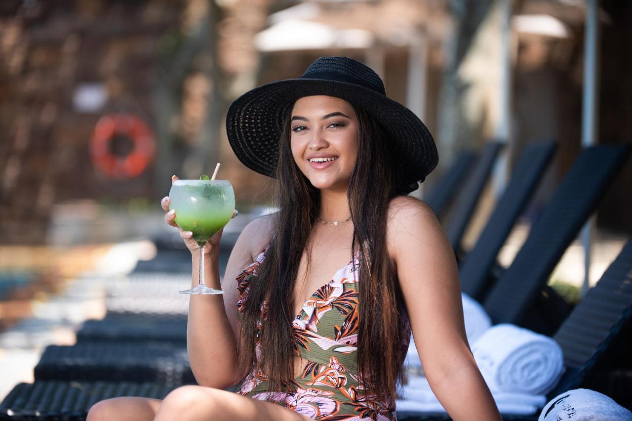 The Capital Zimbali Hotel Ballito Exterior photo A woman wearing a sun hat