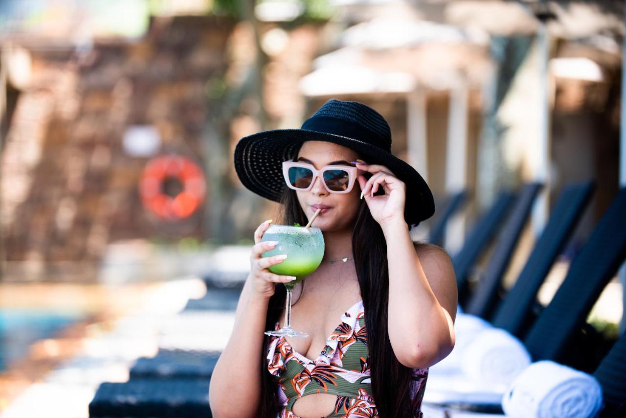 The Capital Zimbali Hotel Ballito Exterior photo A woman wearing a hat