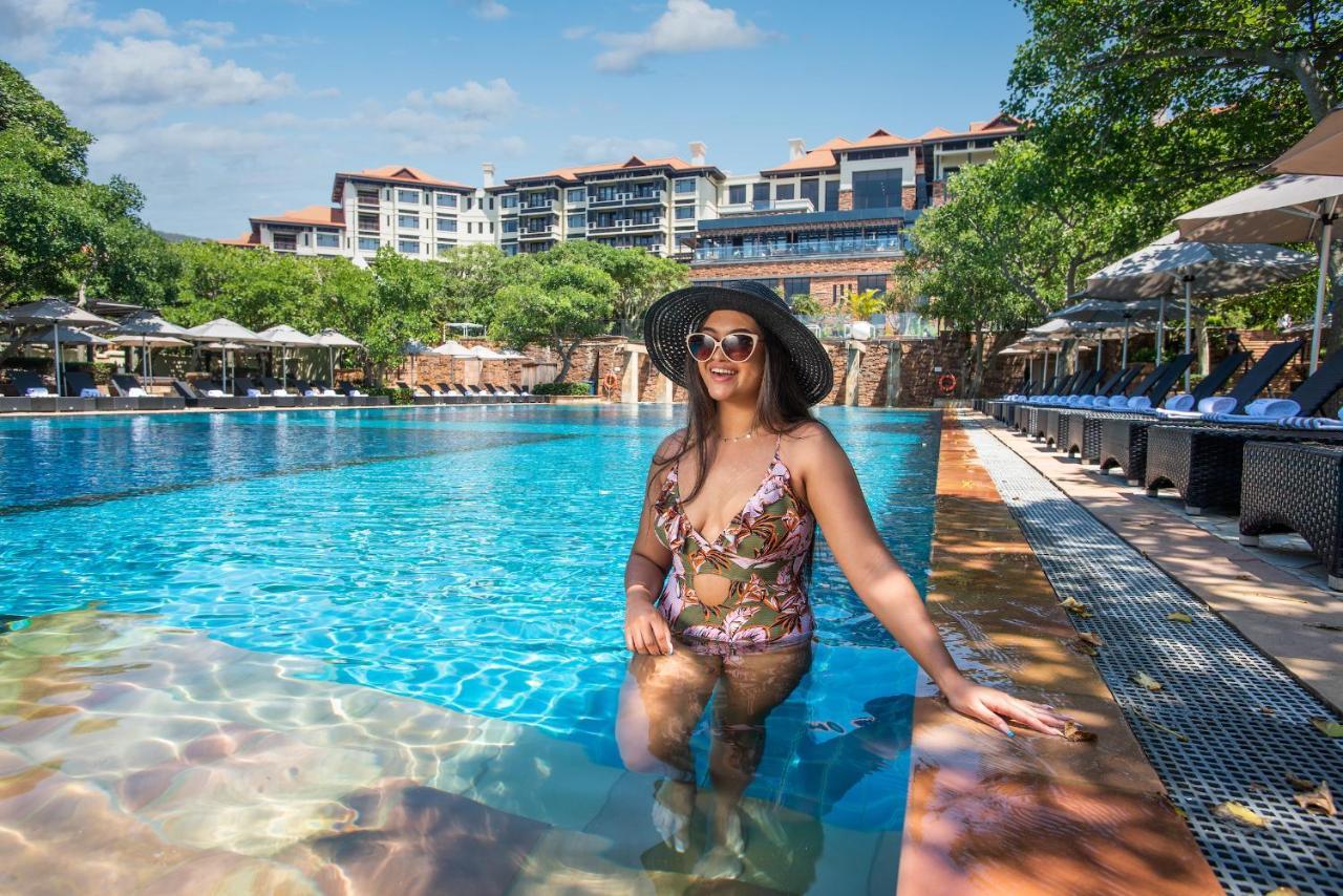 The Capital Zimbali Hotel Ballito Exterior photo A woman wearing a sun hat