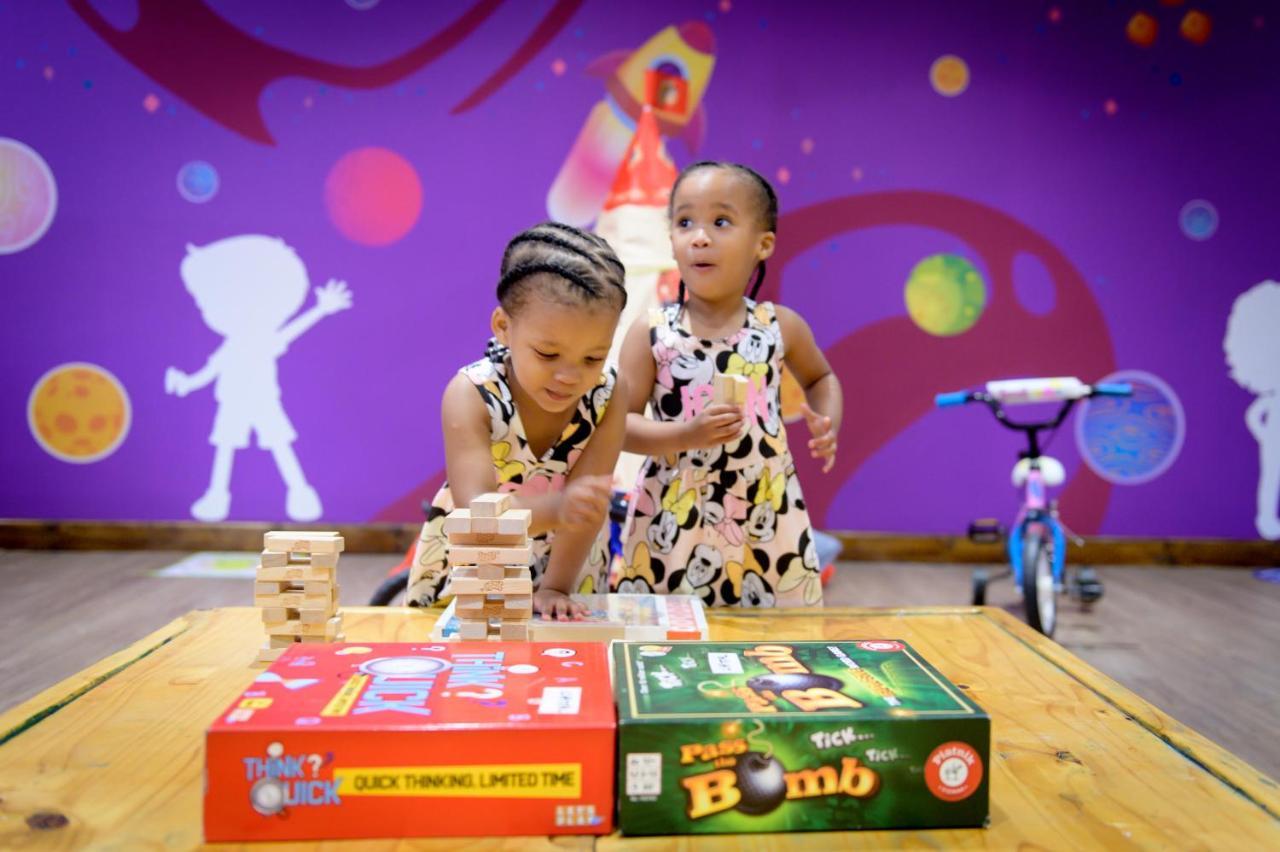 The Capital Zimbali Hotel Ballito Exterior photo Two children playing with board games