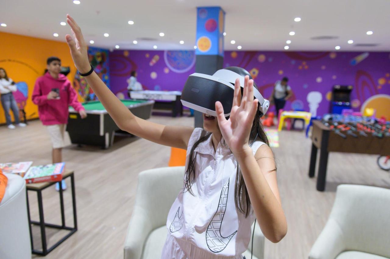 The Capital Zimbali Hotel Ballito Exterior photo A child using a PlayStation VR headset